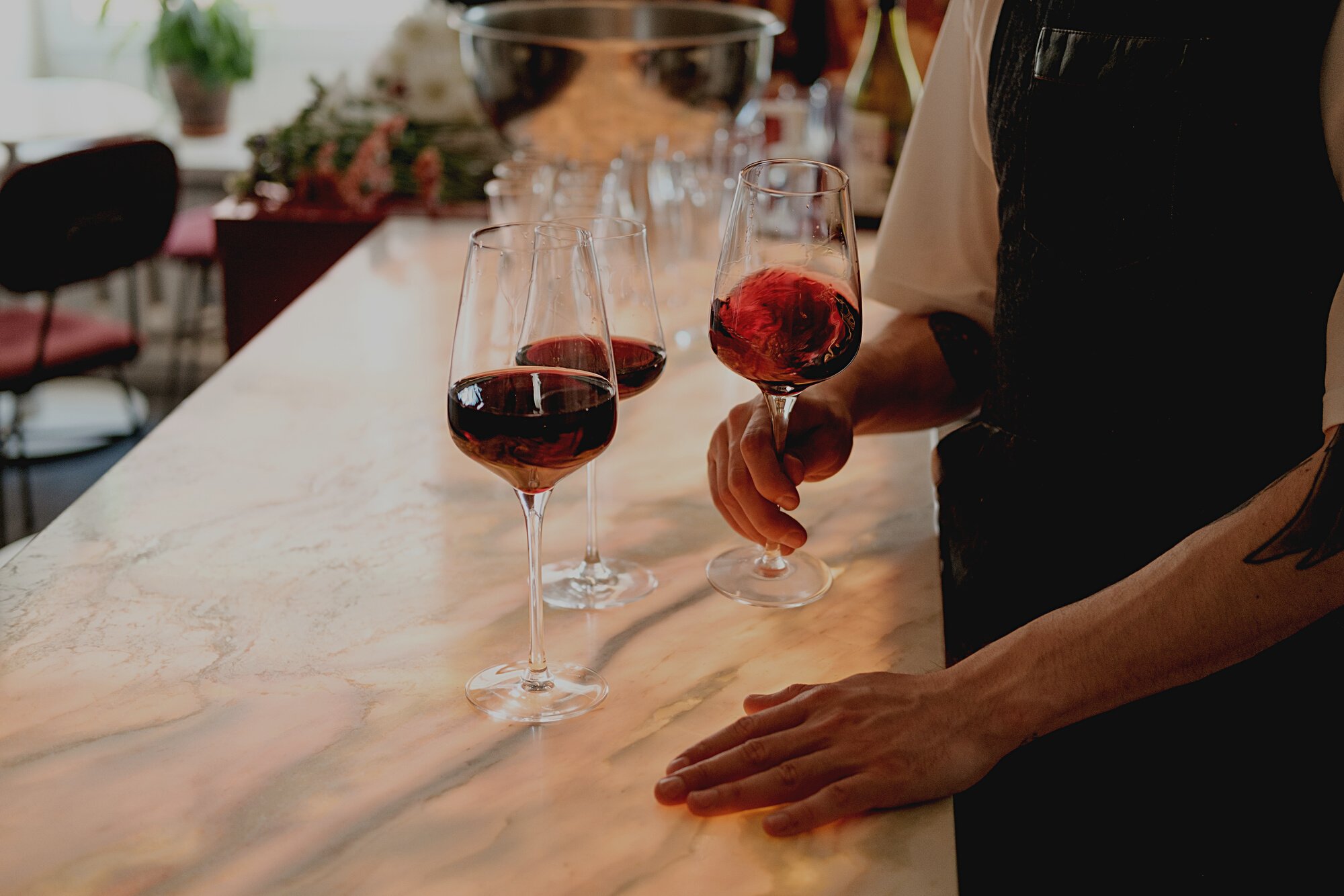 Man in Apron Holding a Glass of Wine